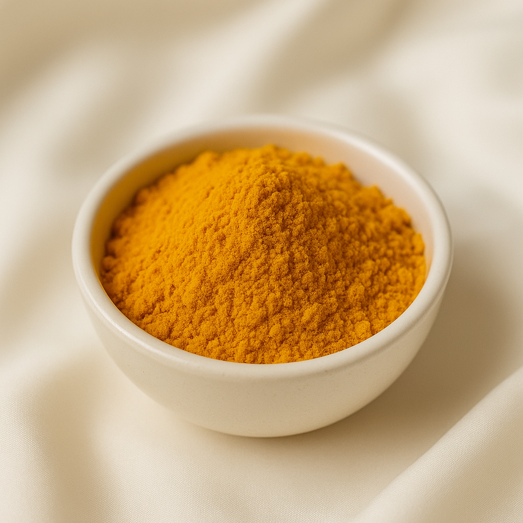 White bowl filled with yellow turmeric powder on a beige fabric background