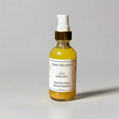 Bottle of Oahu Organics Radiance Protecting Moisturizer on a light gray background