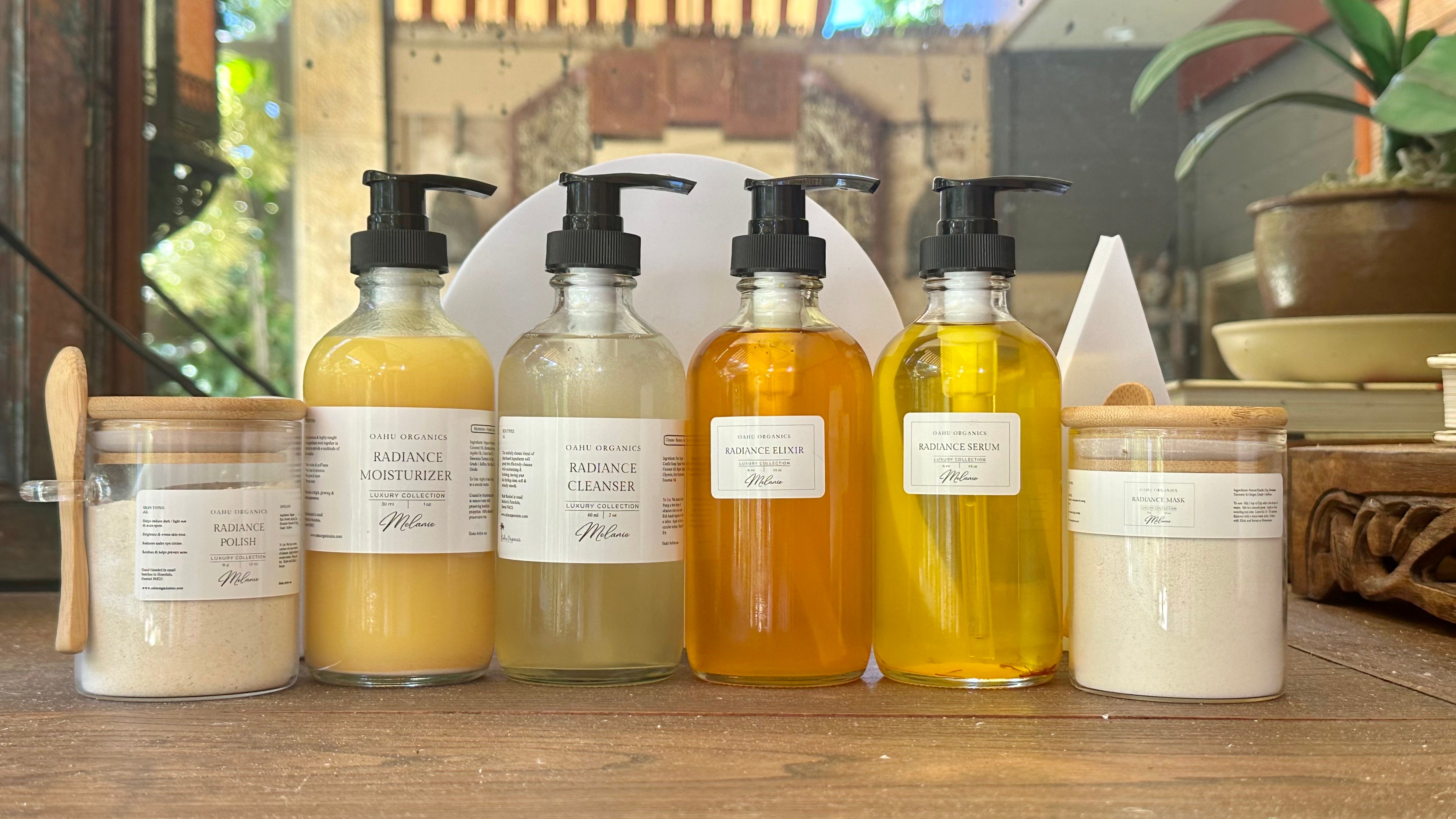 large size bottles of golden skin oils in clear glass bottles, Oahu organics back bar