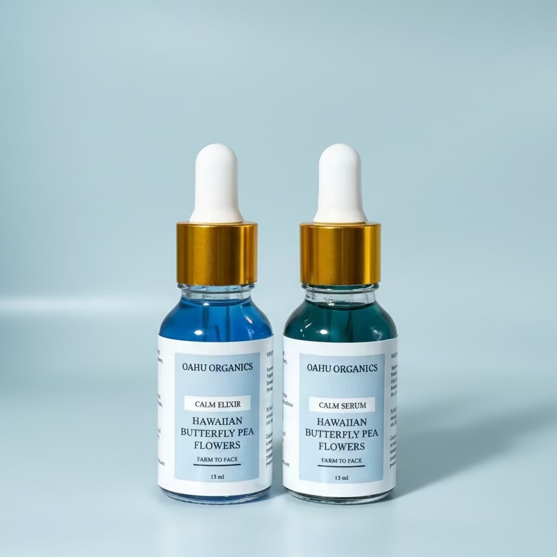 Two bottles of Oahu Organics skincare products on a light blue background