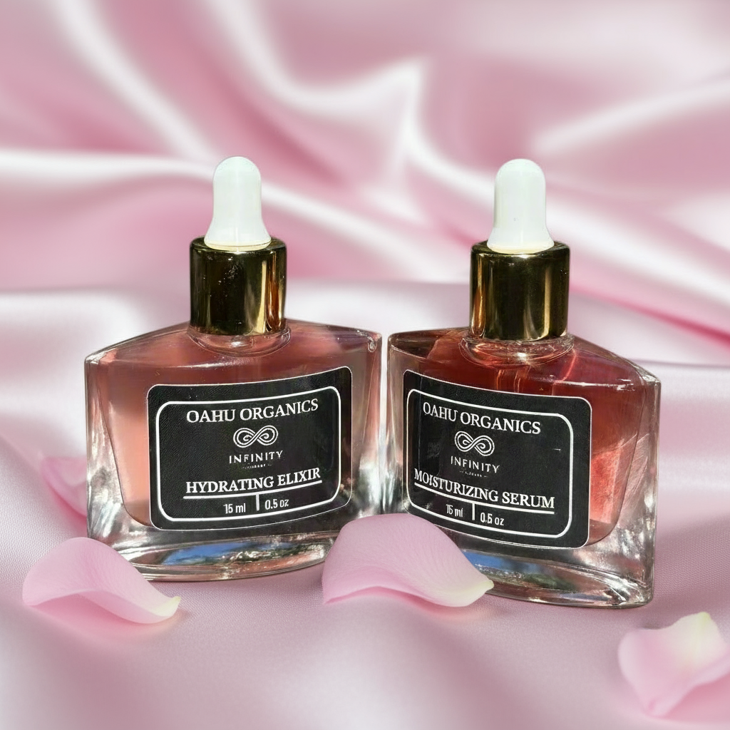 Two bottles of Oahu Organics skincare products on a pink satin background with pink petals.